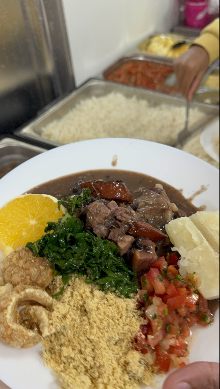 Feijoada brasileña con arroz, farofa, couve y naranja